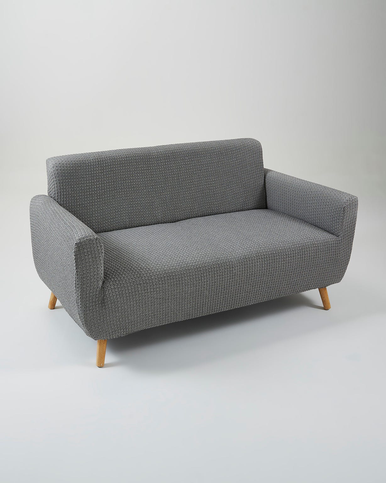Housse de fauteuil ou de canapé bi-extensible.